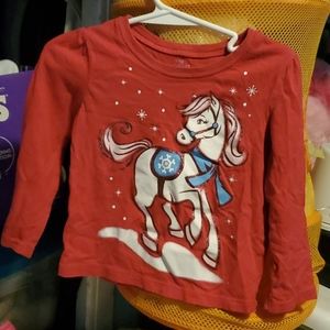 A pink long sleeve with a snow horse on it.